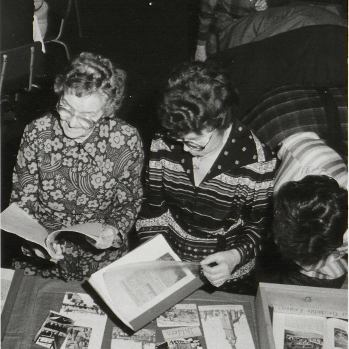 Bild: Festveranstaltung 40 Jahre Fachgruppe Stadtgeschichte am 12. 12. 1987 im Jugendklubhaus „Jürgen Schmidtchen“, Löbauer Str. 49. Gäste beim Betrachten der gefertigten Fachgruppenchronik. Autorin: Marion Wenzel. In: Sächsisches Staatsarchiv, Staatsarchiv Leipzig, 21758 Kulturbund der DDR, Fachgruppe Stadtgeschichte, Nr. 140